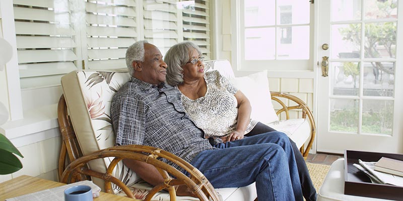 Elderly Couple sitting on their porch
