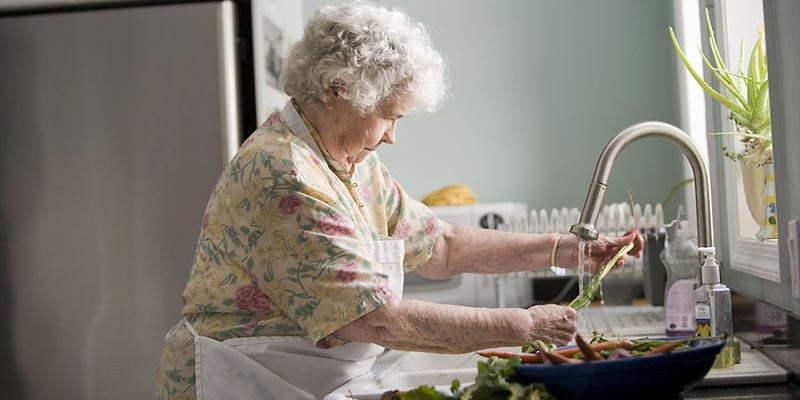 Elderly Woman Cleaning Food