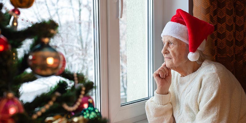Sad Elderly Woman Looking Out the Window